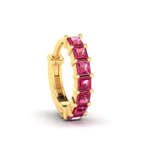 May include: A gold hoop earring with a row of pink square-shaped gemstones.