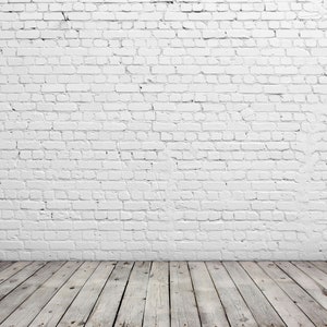 May include: A white brick wall with a wooden floor. The floor is made of light brown wood planks.