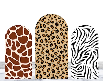 May include: Three arched panels featuring animal print designs. The left panel has a brown and cream giraffe pattern, the center panel has a tan and black leopard print, and the right panel has a black and white zebra stripe pattern. Text reads: Note: Not included arch stand.