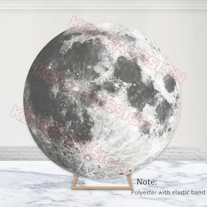 May include: A large, round backdrop featuring a detailed grayscale image of the moon's surface. The backdrop is supported by a gold-colored stand. The text "Note: Polyester with elastic band" is visible.