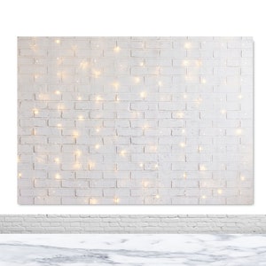 May include: White brick wall backdrop with warm white fairy lights strung across the surface.