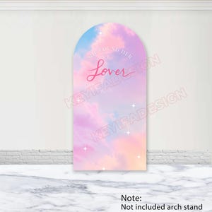 May include: An arched backdrop cover featuring a pastel sky design with pink, purple, and blue clouds. The text "SHE FOUND HER" is printed in white above the word "Lover" in a pink script font. Small white four-pointed stars are scattered across the surface.