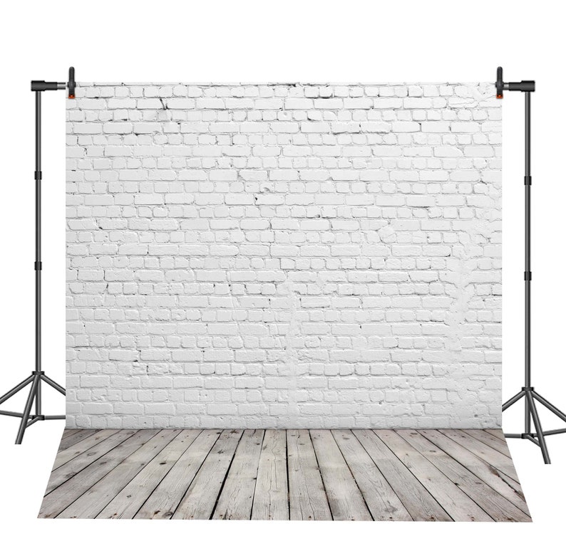 May include: White brick wall backdrop with a wooden floor. The backdrop is set up on a tripod stand.