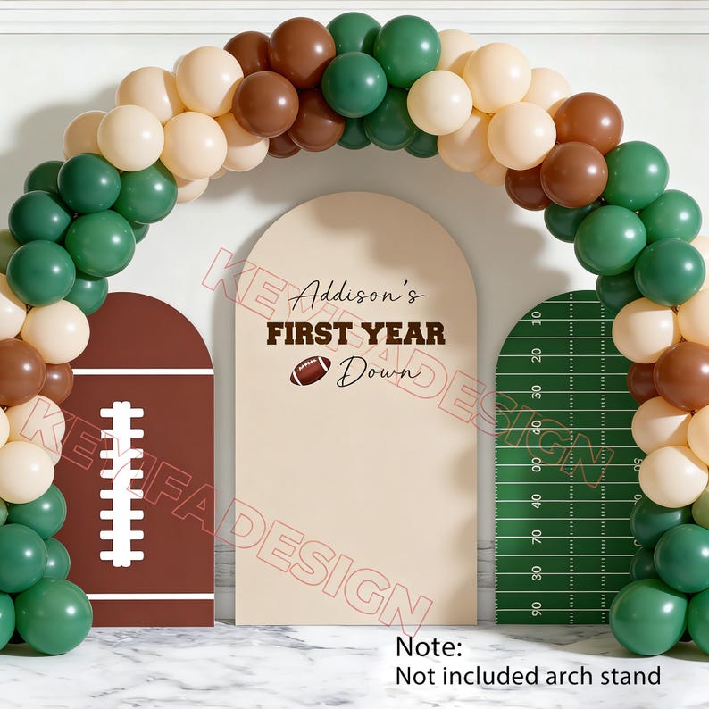 May include: A balloon arch kit featuring a mix of dark green, brown, and cream balloons. The set includes three arched backdrop covers: one brown with a white football lace graphic, one cream with the text Addison's FIRST YEAR Down, and one green field.