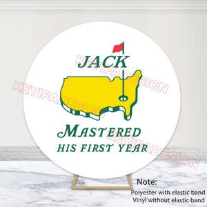 May include: A round white backdrop with a golf-themed design. The design features a yellow outline of a map with a golf flag, the name "JACK", and the text "MASTERED HIS FIRST YEAR".