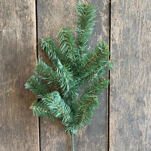 May include: A green artificial pine sprig with a wire stem. The sprig is made of plastic and has a realistic look.