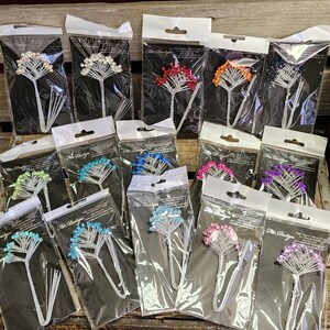 May include: A collection of floral-shaped decorative pins in various colors, including red, orange, blue, and purple, packaged in clear plastic. Each pin features a cluster of beads on silver wire stems. The packaging includes the text "Fite Designs".