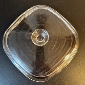 Pyrex 10 1/4”  Square lid #A12c with knob handle and it’s heavy, 2lb. 12 ounces