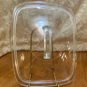 Pyrex #624 rectangular lid with blue tint & fin// D shaped handle, interior measurement of the flange is 8 1/5”x 6 1/2” or 21cm x 16.5 cm