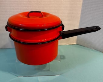 VTG Red-Orange enamelware double boiler, two pots, one lid  and  with black handles, about 5.5' tall  when stacked and 6.5' wide