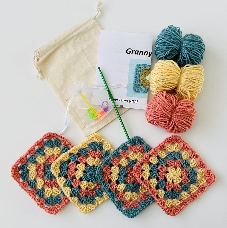 May include: A crochet kit with instructions, yarn in teal, yellow, and coral, a crochet hook, stitch markers, and a drawstring bag. The kit includes four completed granny squares in the same colors.
