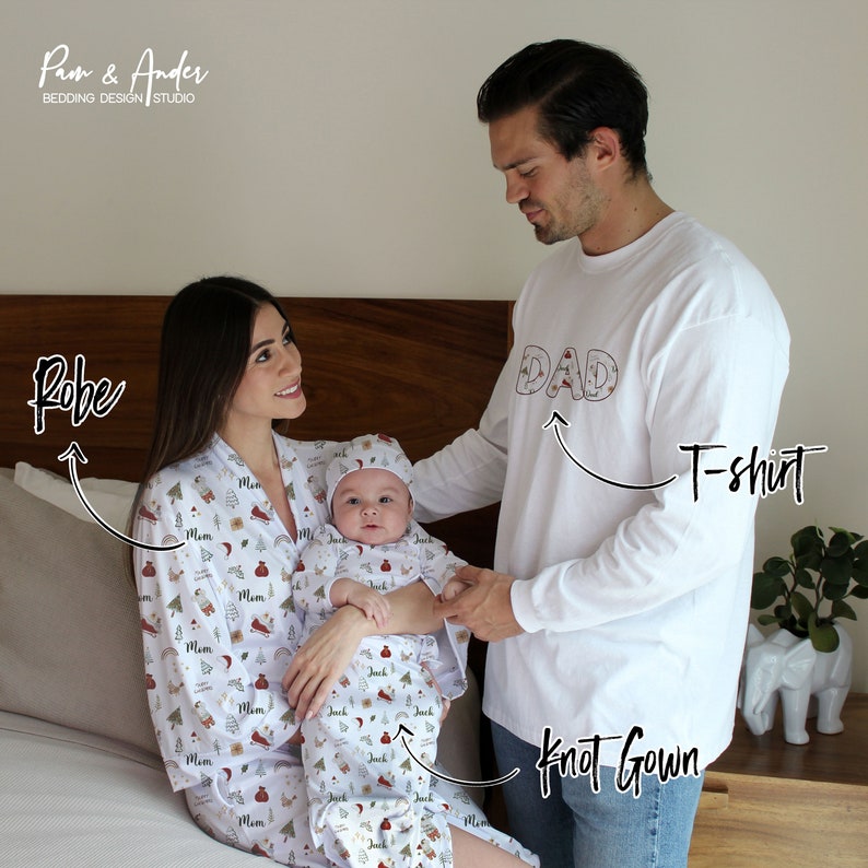 May include: A family matching Christmas pajama set with a white background and a red and green pattern. The set includes a robe for a woman, a long-sleeve t-shirt for a man, and a knot gown for a baby. The robe has the word "Mom" repeated on it, the t-shirt has the word "Dad" on it, and the knot gown has the word "Jack" repeated on it.