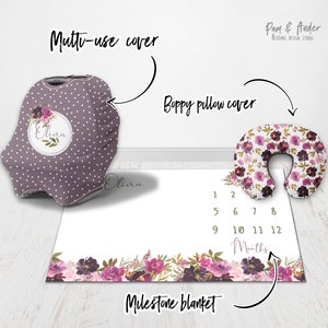 May include: A set of three baby items in a floral pattern with a purple and white colour scheme. The set includes a multi-use cover, a boppy pillow cover, and a milestone blanket. The blanket has numbers 1-12 printed on it to track a baby's growth.