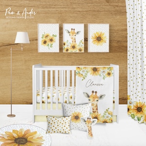 May include: A white crib with a yellow and white sunflower crib bedding set. The bedding includes a blanket, fitted sheet, and pillow. There is a yellow and white sunflower rug on the floor. The crib is decorated with three framed prints of sunflowers and a giraffe. The name "Clarissa" is written on the blanket.