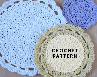 May include: Three crocheted doilies in white, yellow, and purple. The doilies are round and have a scalloped edge. The text "CROCHET PATTERN" is written in the center of the yellow doily.