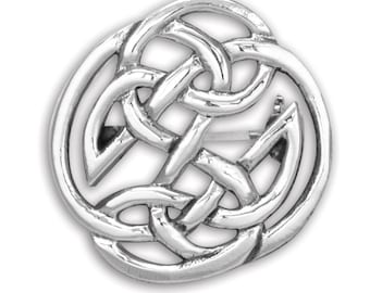 May include: A silver Celtic knot brooch with a intricate design. The brooch is round and has a detailed knot pattern.