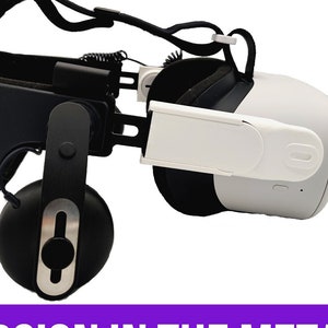 May include: A black and white 3D printed adapter for a Meta Quest 2 virtual reality headset. The adapter is designed to attach to the headset's strap and features a white plastic piece that extends from the side. The text "DAS ADAPTER MADE FOR QUEST 2" and "BEST VERSION IN THE METAVERSE" is displayed on the image.