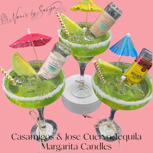 May include: Three margarita candles with green liquid, lime slices, and straws. The candles are topped with a white rim and are decorated with miniature bottles of Casamigos and Jose Cuervo tequila and miniature umbrellas. The text on the image reads 