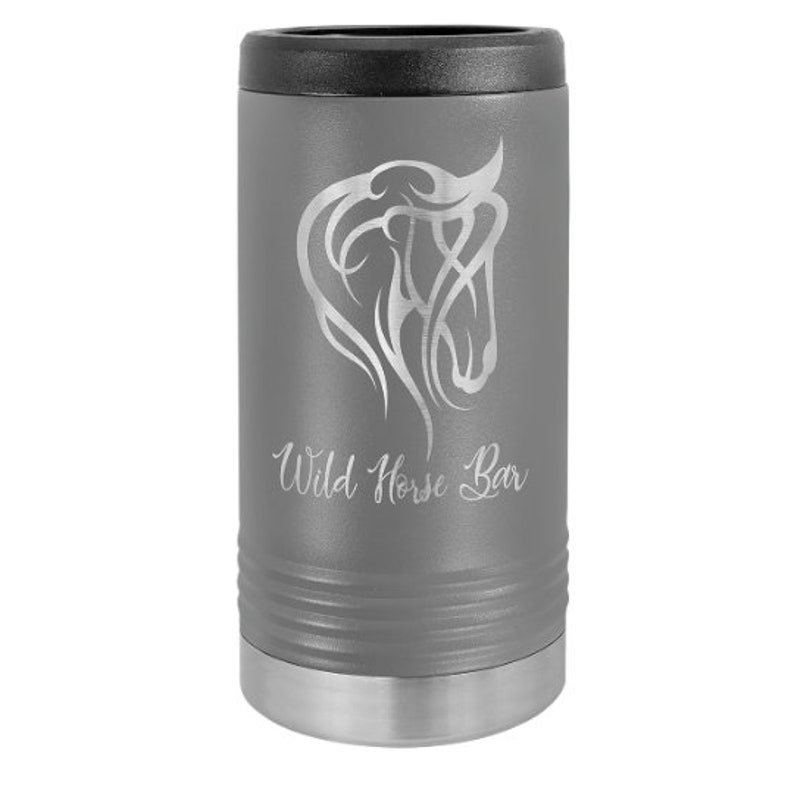 May include: Gray stainless steel can cooler with a black lid. The cooler features an engraved design of a horse's head and the text "Wild Horse Bar".