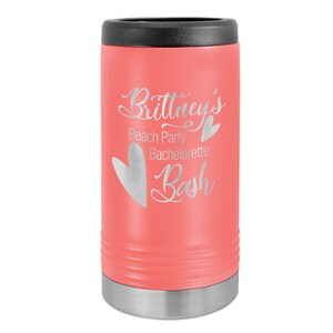 May include: A coral pink stainless steel can cooler with a silver lid. The cooler is engraved with the text "Brittney's Beach Party Bachelorette Bash" and a heart.