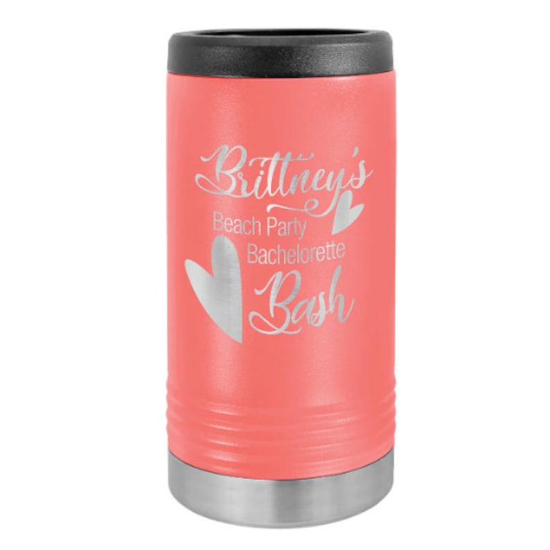 May include: A coral pink stainless steel can cooler with a silver lid. The cooler is engraved with the text "Brittney's Beach Party Bachelorette Bash" and a heart.