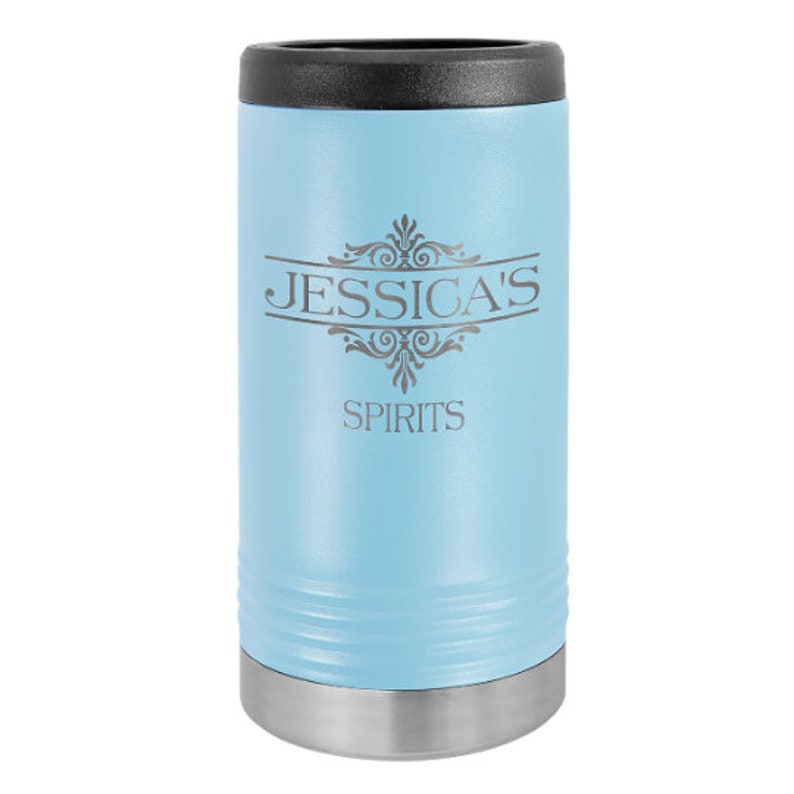 May include: A light blue stainless steel can cooler with a black lid. The cooler is engraved with the text "JESSICA'S SPIRITS" and a decorative design.