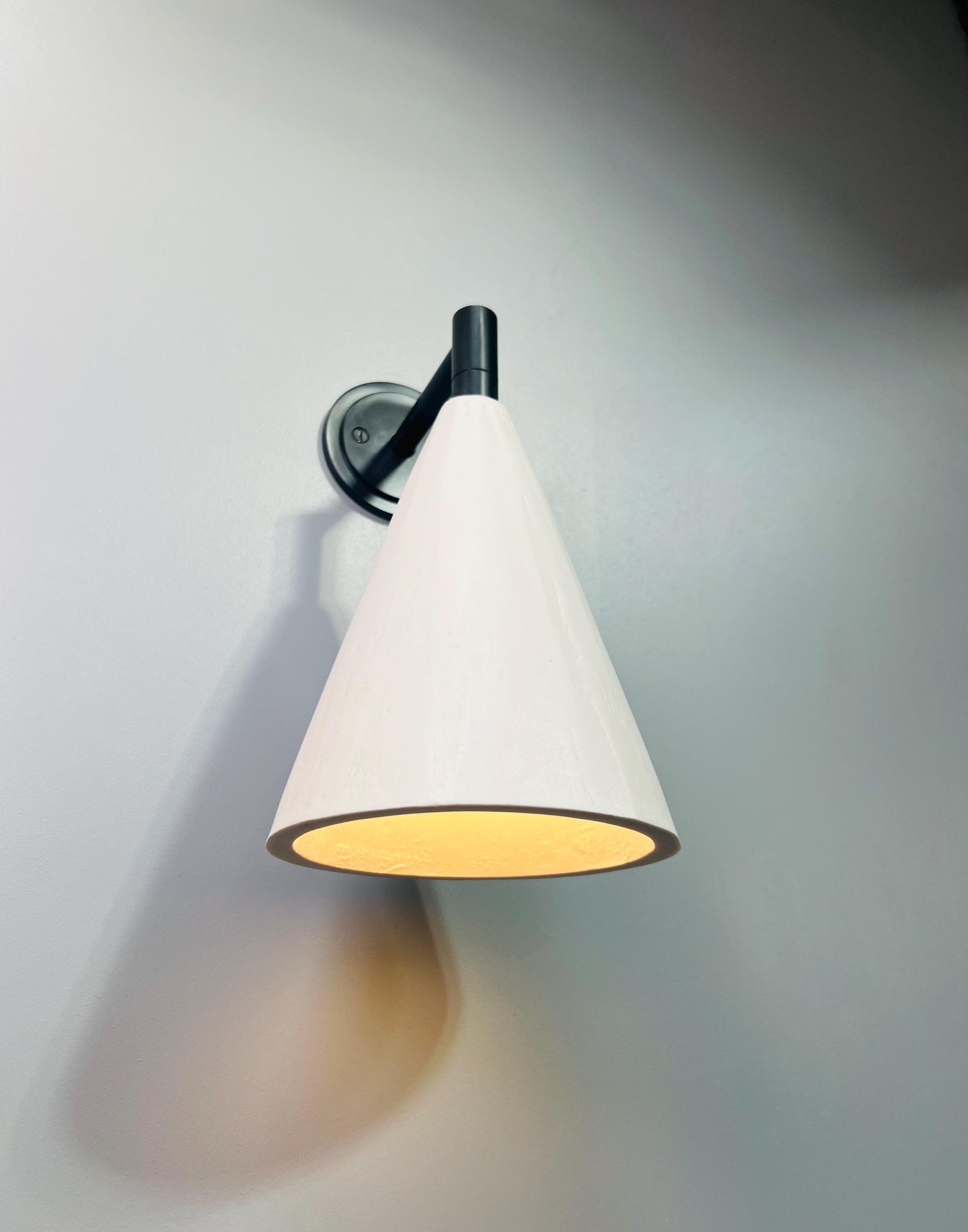 Bronze and plaster cone wall light