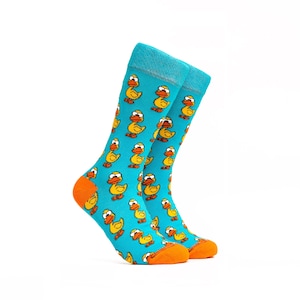 May include: A pair of blue socks with a yellow duck pattern. The socks have orange trim around the top and bottom.