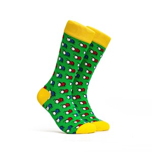 May include: A pair of green socks with a pattern of red, white, and blue ladybugs. The socks have yellow tops.
