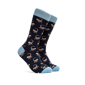 May include: A pair of blue and brown socks with a monkey pattern. The socks have a light blue cuff.
