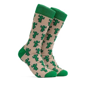 May include: A pair of tan socks with a green cactus pattern. The socks have green tops.