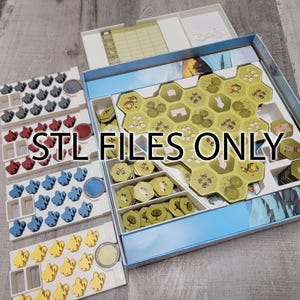 May include: A white organizer with multiple compartments for storing game pieces. The compartments are filled with various colored tokens and tiles. The text "STL FILES ONLY" is printed on the organizer.