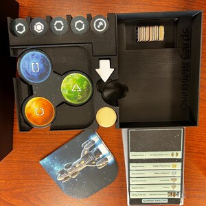 May include: A black plastic organizer with compartments for game pieces and cards. The organizer has a label that says "Overview Cards".