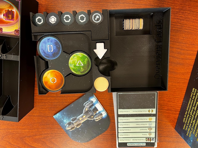 May include: A black plastic organizer with compartments for game pieces and cards. The organizer has a label that says "Overview Cards".