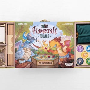 May include: Flamecraft Duels Deluxe Edition board game, open to reveal components. The box art features two dragons playing a game. Includes wooden game pieces, cards, and a green velvet bag.