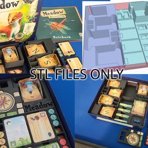以下が含まれることがあります： 「Meadow」というボードゲーム。箱、ルールブック、ゲームの駒が含まれています。箱のイラストにはイタチが描かれ、「Meadow」の文字があります。ゲームの駒は黒いトレイに整理されています。「STL FILES ONLY」の文字が見えます。