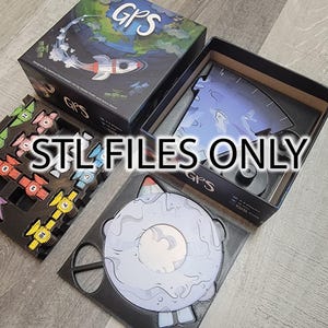 May include: A board game called "GPS" with a rocket ship and a blue planet on the box lid. The game includes a black game board with colorful pieces and a black box with a blue and white game piece.