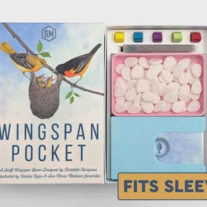May include: Wingspan Pocket board game box and open interior. The box cover features two birds at a nest with the text Wingspan Pocket. The interior contains a pink tray filled with white egg tokens, a light blue card holder, and five colored cubes.