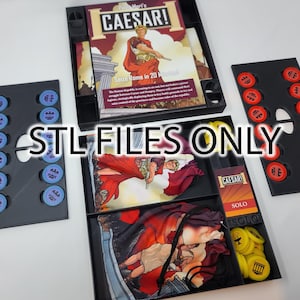 May include: A board game titled "Caesar!" with game pieces and cards. The game components are arranged in black trays. The game includes cards, tokens, and a game board. The text "STL FILES ONLY" is overlaid on the image.