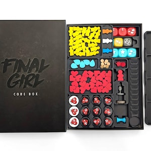 May include: A Final Girl Core Box board game set with a black lid featuring the title and Van Ryder Games logo. The open box contains black plastic trays filled with yellow character figures, red heart tokens, blue teardrop tokens, and dice.