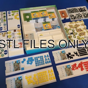 May include: A board game organizer with various components, including game tiles, cards, and player pieces in blue, yellow, red, and black. The text "STL FILES ONLY" is visible. The game pieces are arranged in trays and boxes, suggesting a strategy or tabletop game.
