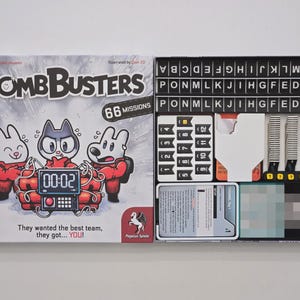 May include: An open board game box for "Bomb Busters", featuring cartoon animal characters on the cover. Inside are letter tiles, number tiles, and cards. The game includes 66 missions.