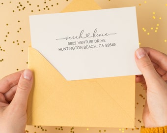 May include: A white envelope with a return address label that reads "sarah & kevin 5802 VENTURI DRIVE HUNTINGTON BEACH, CA 92649".