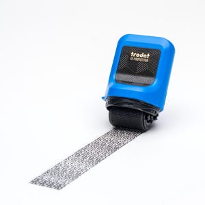 May include: A blue and black ID protector roller with the text "trodat ID PROTECTOR" on the side. The roller is leaving a black line of dots on a white surface.