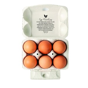 May include: A carton of six brown eggs in a white cardboard egg carton. The carton has a label that reads "Egg Handling" with instructions on how to store and wash the eggs.
