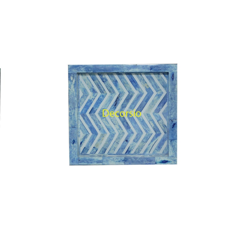 May include: A blue tray with a white chevron pattern. The tray has a light blue border and the word "Decorslo" is printed in yellow in the center.