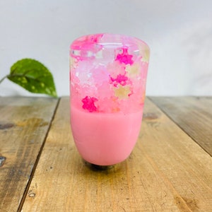 May include: Pink and white resin gear shift knob with a clear top filled with pink and white confetti.