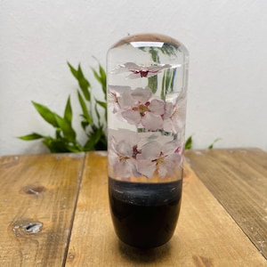 Pomo de palanca de cambios con diseño de flor sumergida, cilindro en forma de M, color flor de cerezo, negro