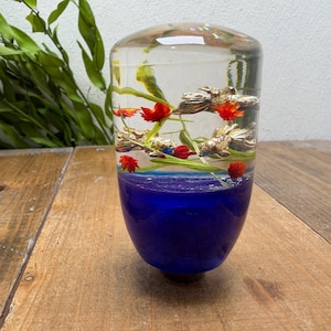 Manopla de câmbio com flor subaquática, aquário com peixinho dourado, azul
