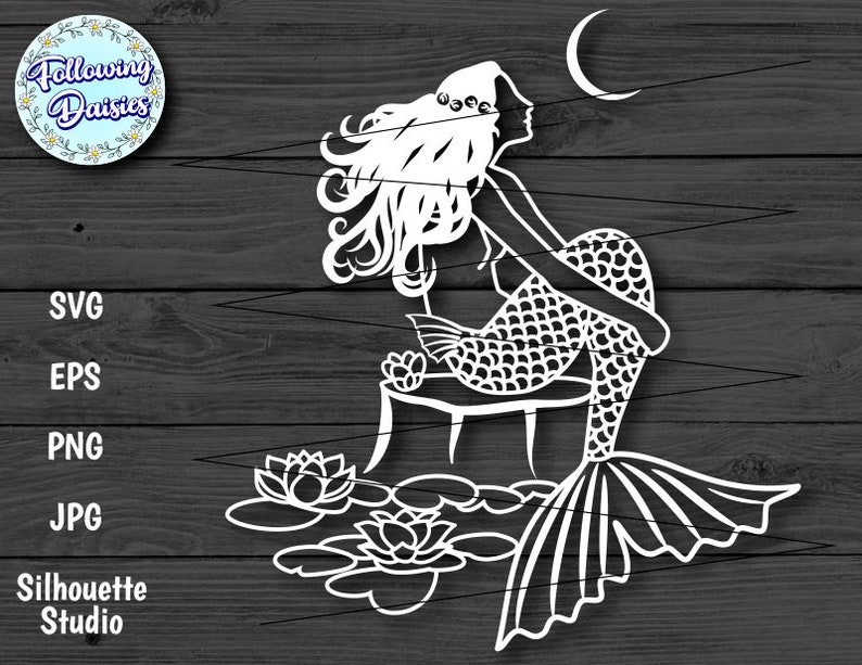 May include: A white silhouette of a mermaid sitting on a rock with a crescent moon above her. She has long flowing hair and a fishtail. She is surrounded by water lilies.